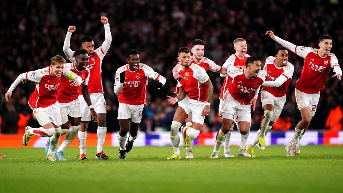 The Arsenal players celebrate advancing to the next round in a penalty shootout.