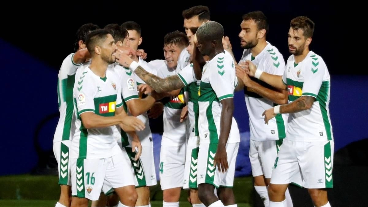 The Elche players celebrate a goal