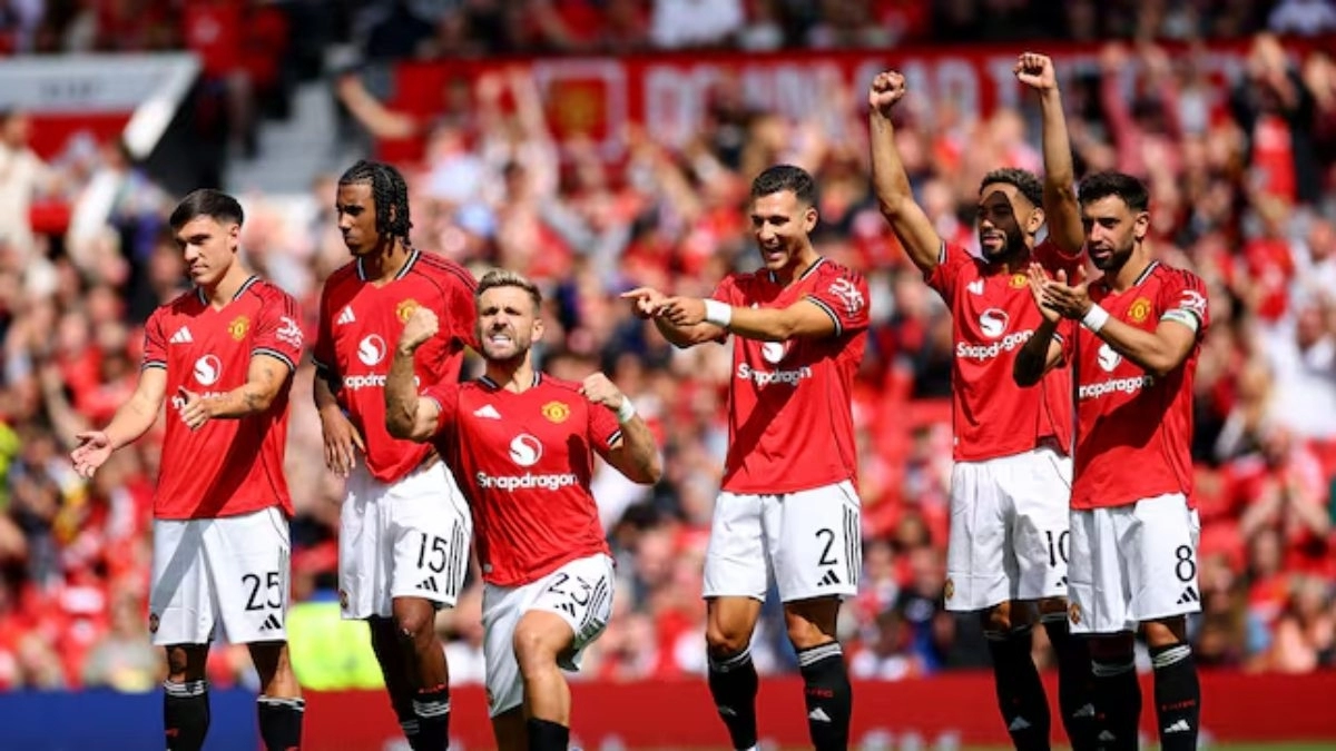 The Manchester United footballers celebrate a goal in a penalty shootout.